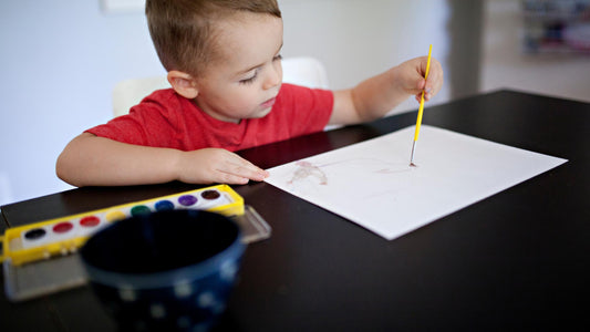 A small boy wearing red colour t shirt